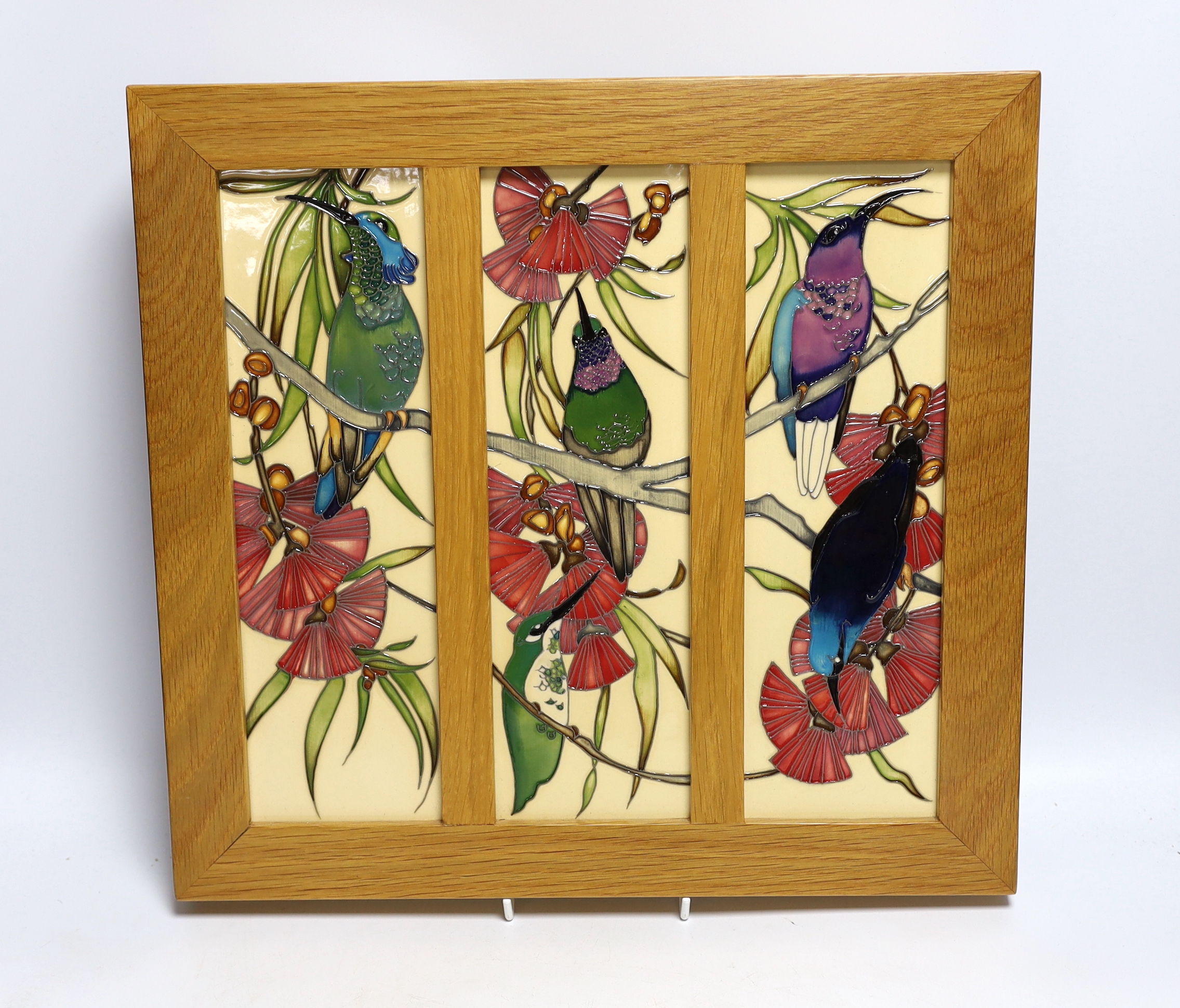 A framed Moorcroft Rachel Bishop triple wall plaque of humming birds, 36 x 38cm total